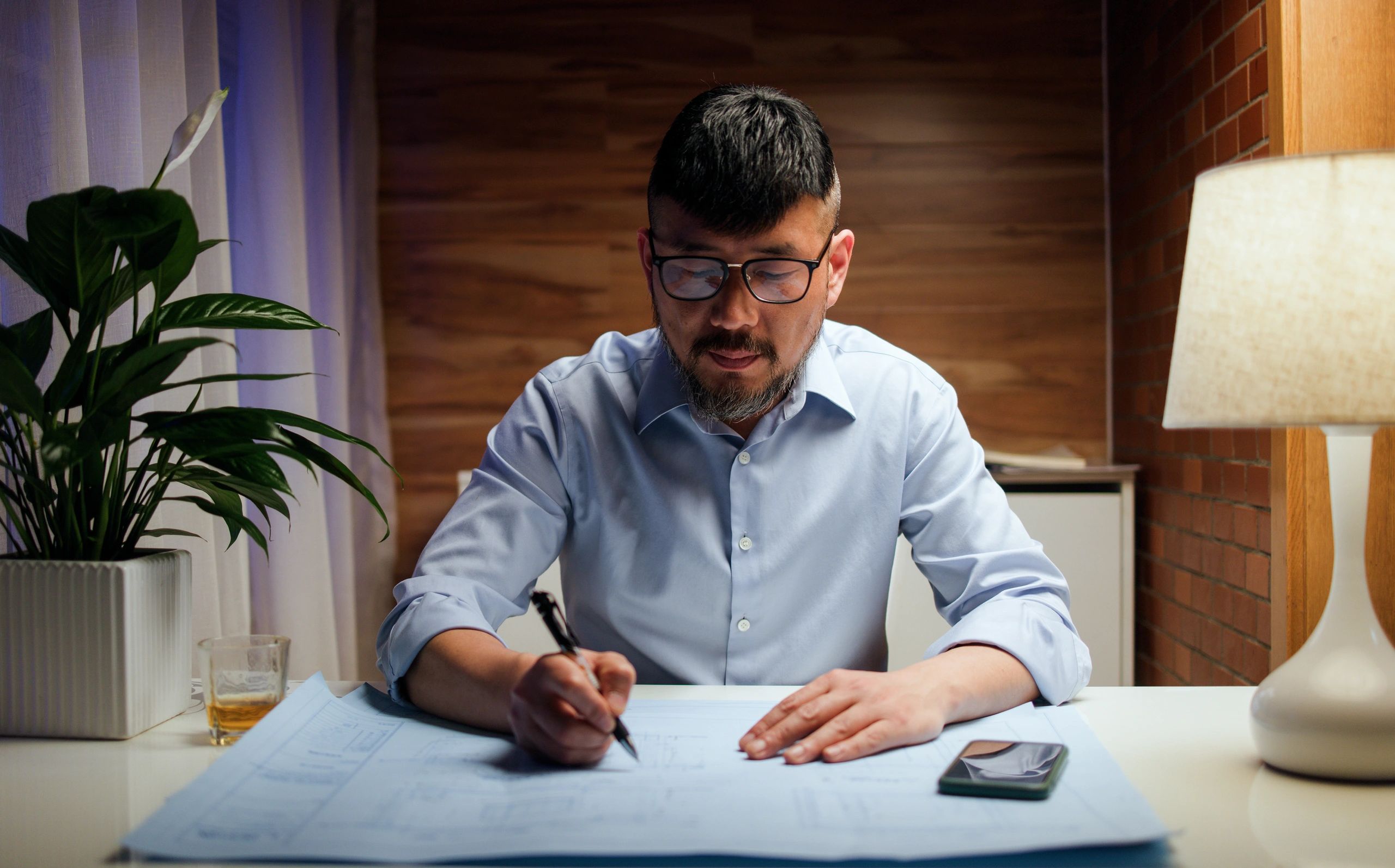 Professional working on plans and visual revisions